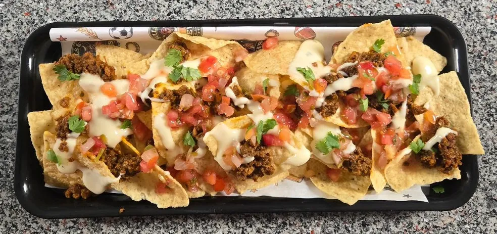 Long tray of loaded nachos served at Bulls & Brews